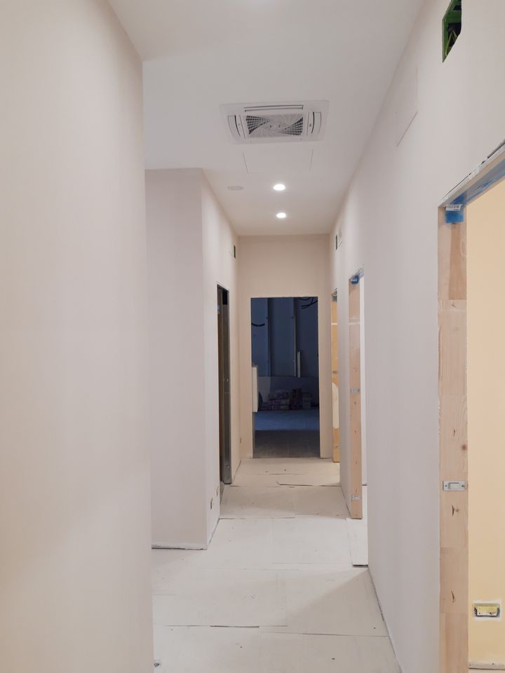 Corridor painted in a warm light tone, with doors still to be fitted